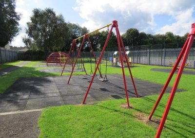 Children's play area with swings and climbing frames