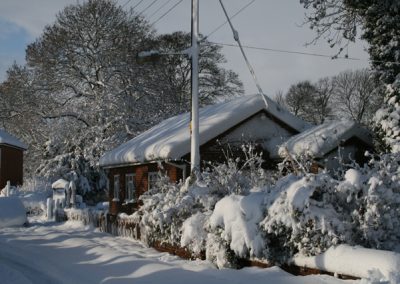 A view of a local bungalow covered in snow