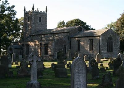 A view of the churchyard with the church to the rear