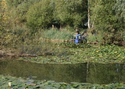 An angler on the bank of the lake in the nature reserve near Messingham